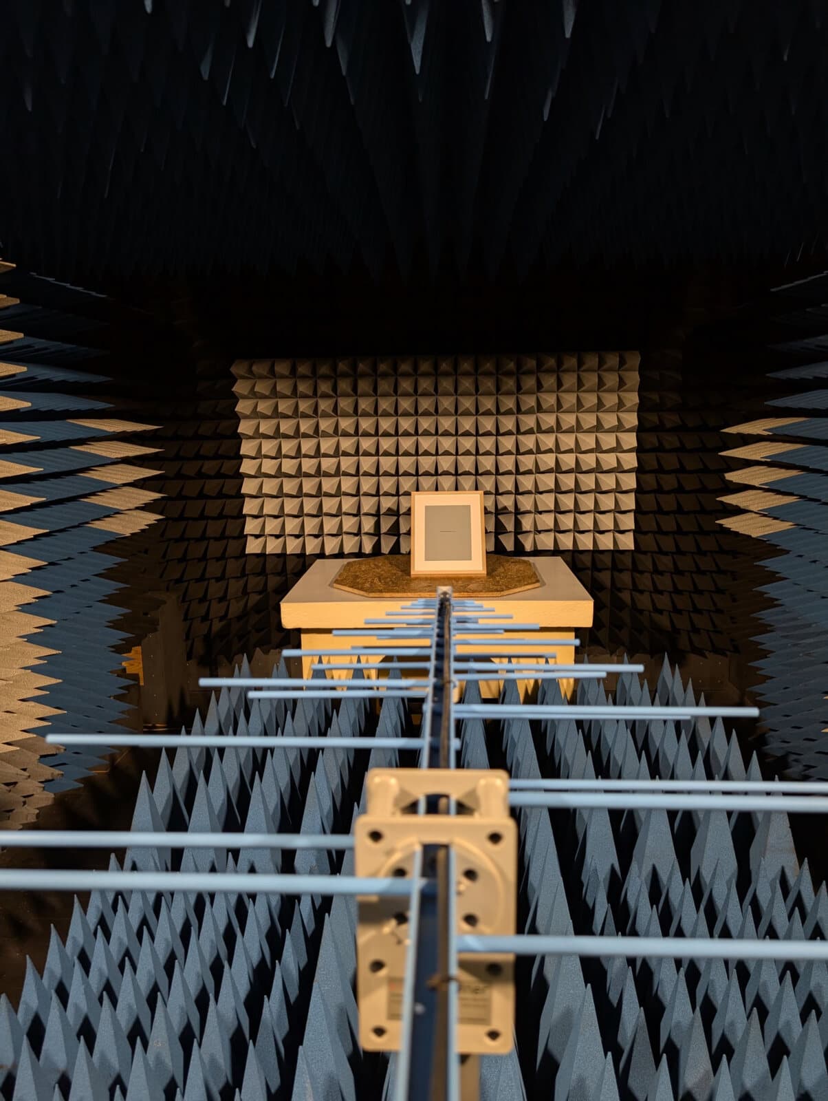 Measurement antenna pointed at an OpenPaper device during EMC testing