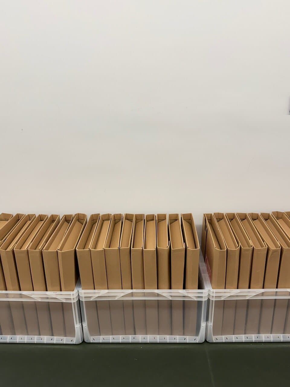 Prepared book mailers stored upright in crates